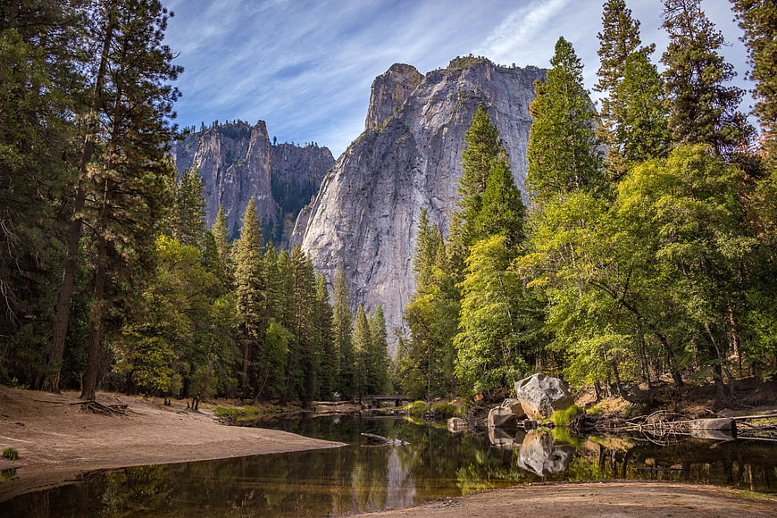 Majestic granite cliffs and river in a lush forest landscape
