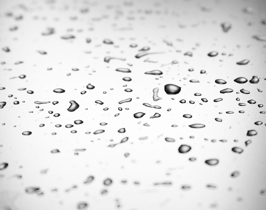 Close-up of water droplets on a white surface