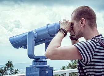 Man Looking Through Coin-Operated Binoculars at Scenic View