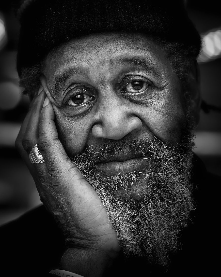 Black and white portrait of elderly man with beard and hat