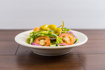 Fresh Vegetable Salad with Tomatoes and Peppers on White Bowl