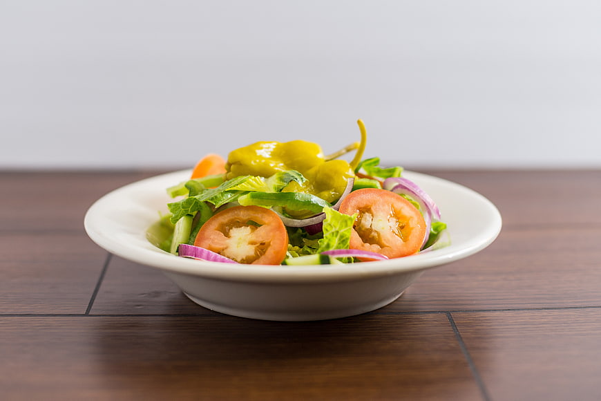 Fresh Vegetable Salad with Tomatoes and Peppers on White Bowl