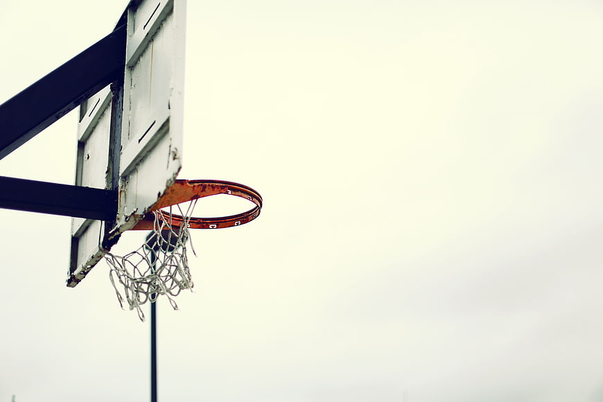 Weathered Basketball Hoop Against Overcast Sky