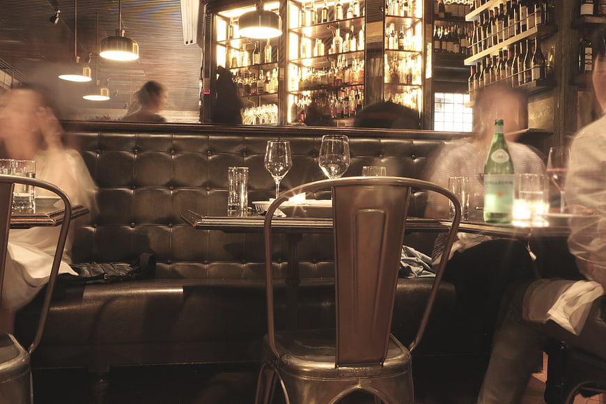 Motion Blur Interior of a Busy Restaurant with Wine Glasses