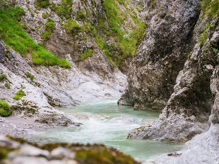 Turquoise river flowing through rocky mountain gorge