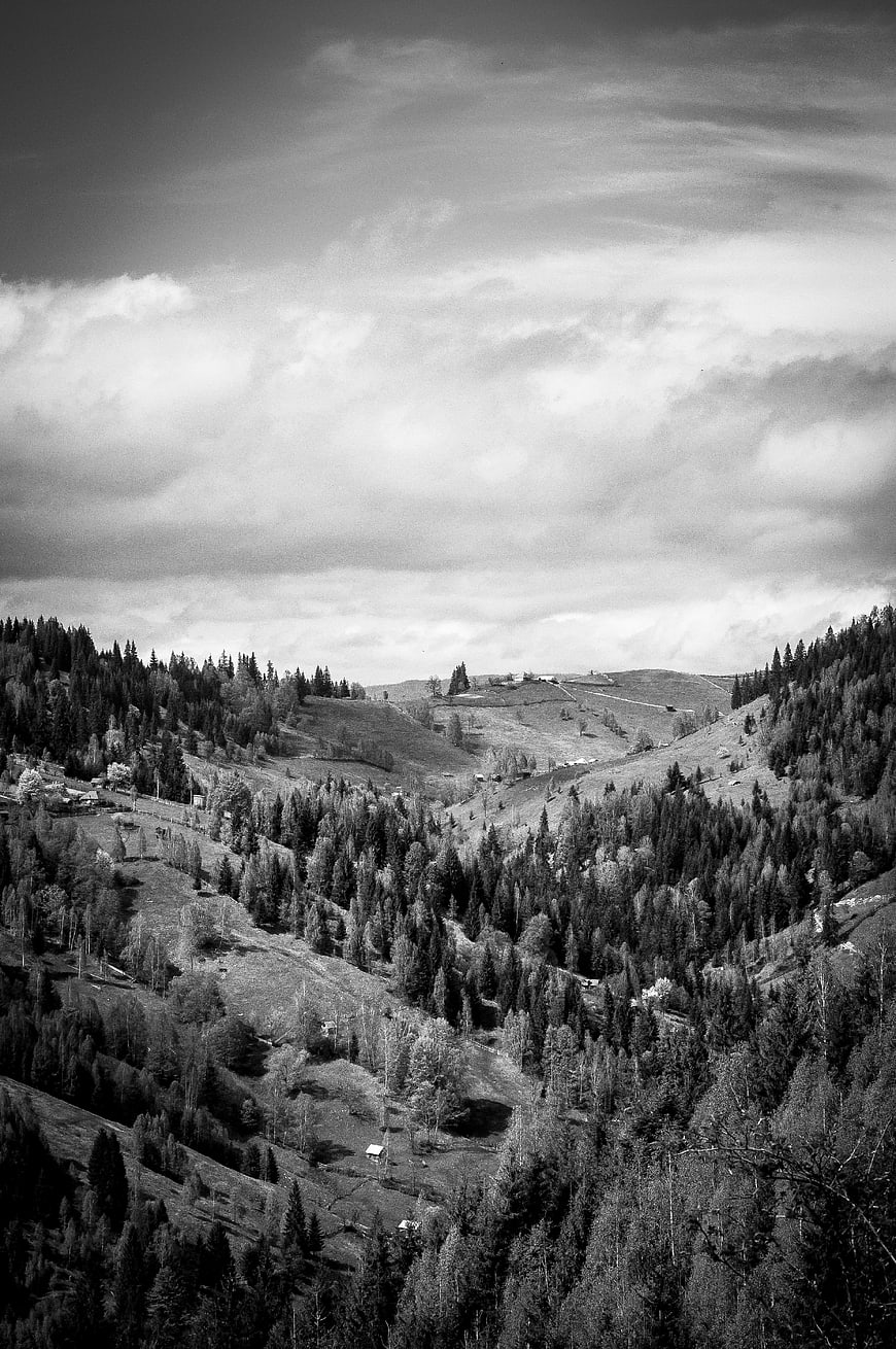 Black and white mountain valley landscape with clouds