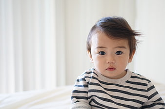 Cute Asian Toddler Boy in Striped Shirt Looking at Camera