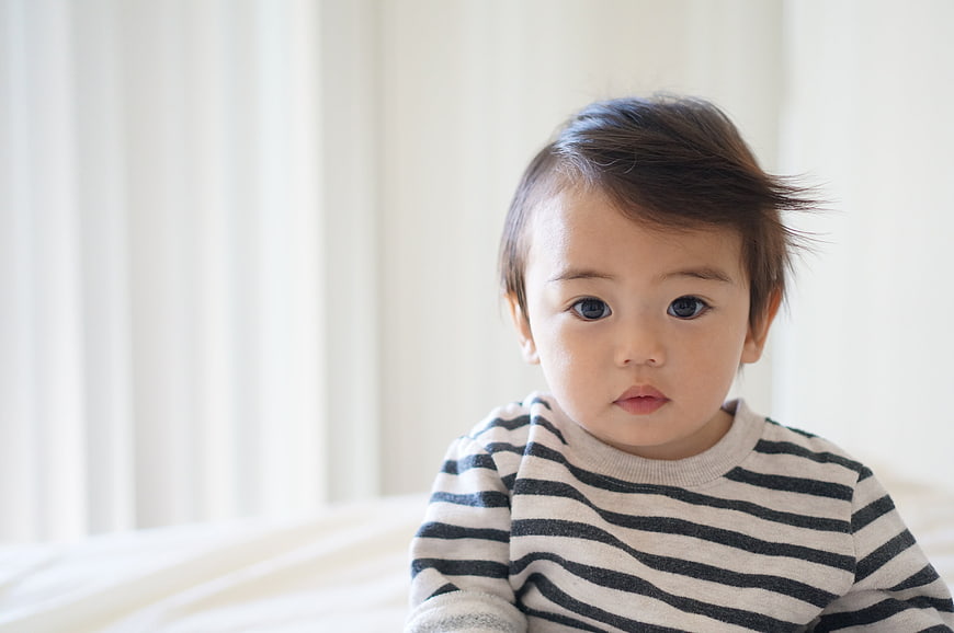 Cute Asian Toddler Boy in Striped Shirt Looking at Camera