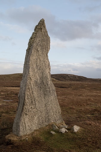 Ancient Standing Stone in Scottish Moorland Landscape