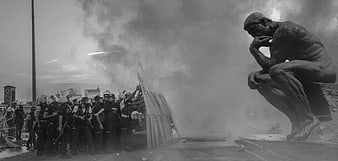 Black and white photo of riot police facing The Thinker statue