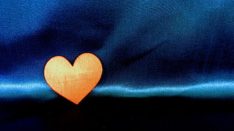 Wooden Heart on Blue Fabric Background