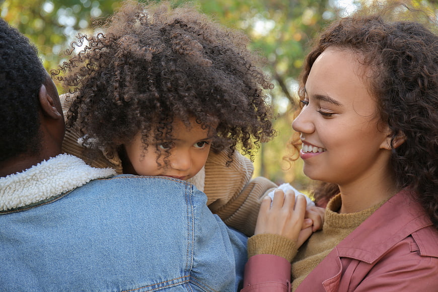 Happy African American Family Embracing Outdoors in Autumn