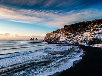 Dramatic Winter Seascape with Snowy Cliffs and Ocean Waves