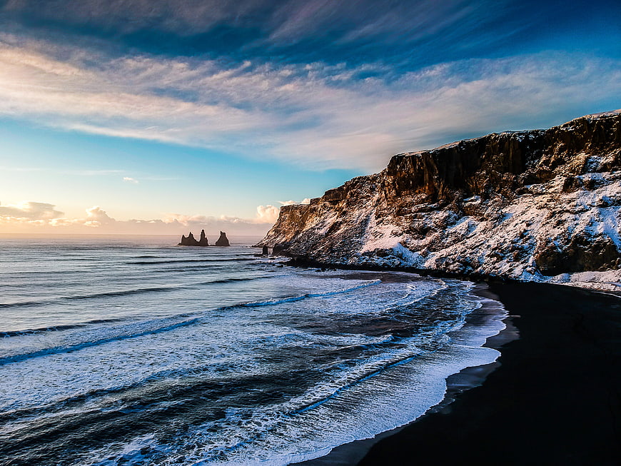 Dramatic Winter Seascape with Snowy Cliffs and Ocean Waves