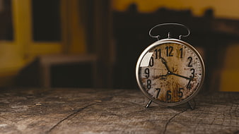 Vintage Rusty Alarm Clock On Weathered Wooden Table