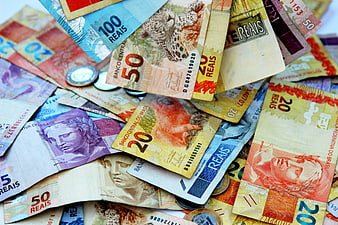 Scattered Brazilian Real Banknotes And Coins Close-Up