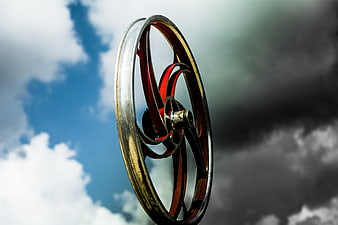 Vintage Bicycle Wheel Against Dramatic Cloudy Sky