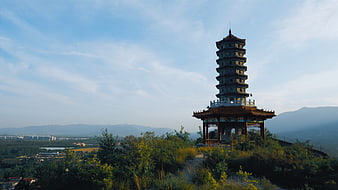 Traditional Chinese Pagoda on Hilltop with Mountain View