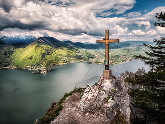 Wooden Summit Cross Overlooking Alpine Lake and Mountains