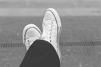 Black and white sneakers on asphalt background