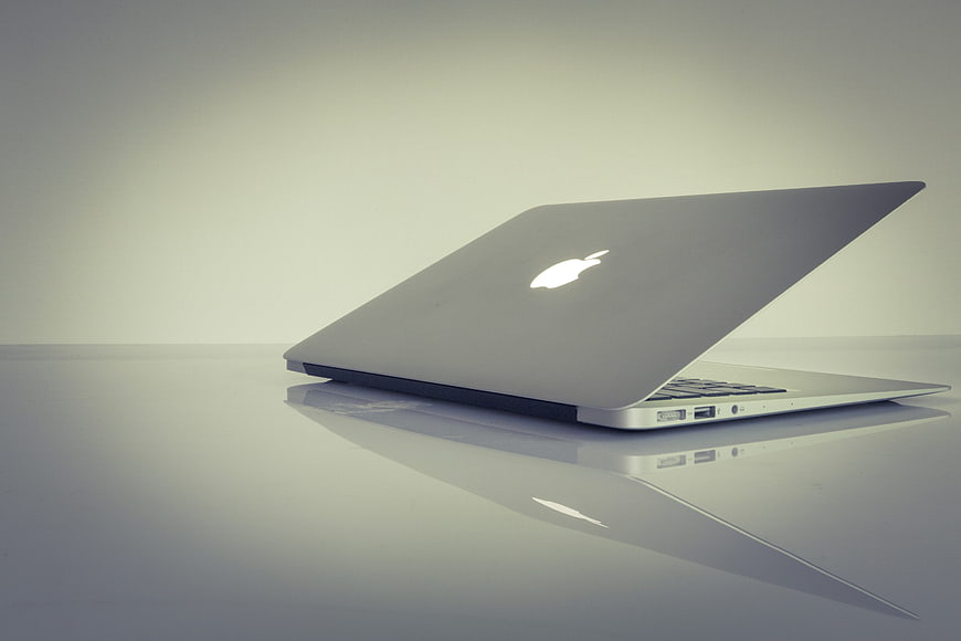 Silver Apple MacBook Air Laptop On Reflective Surface
