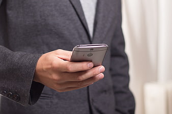 Businessman holding smartphone in hand