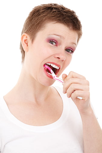Young Woman Brushing Teeth with Pink Toothbrush