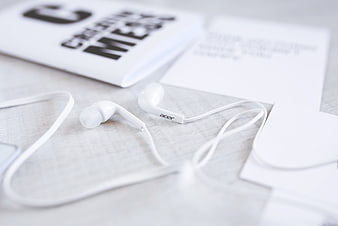 White Acer Earphones on Minimalist Desk with Magazine