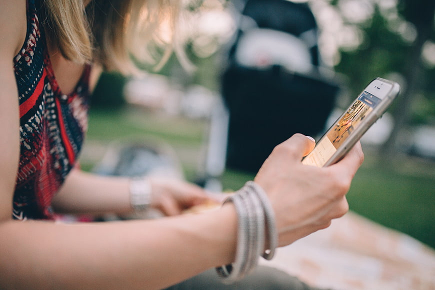 Woman using smartphone at outdoor picnic