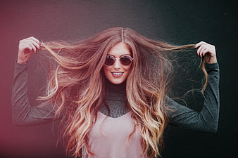 Stylish Woman with Long Wavy Hair and Sunglasses