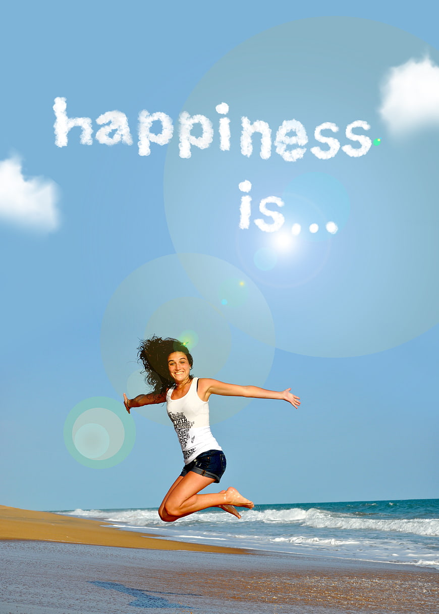 Happy woman jumping on beach with inspirational text overlay