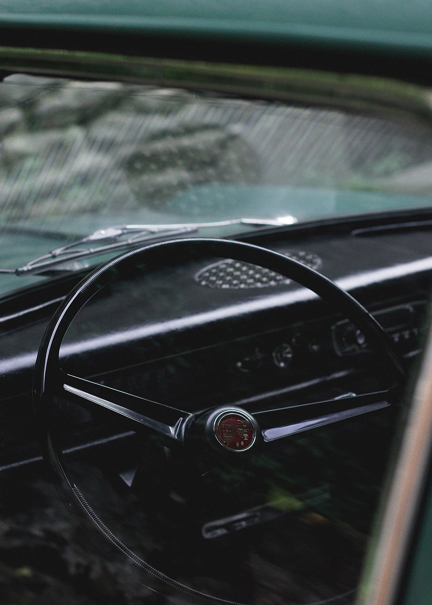 Vintage Car Interior with Classic Steering Wheel and Dashboard