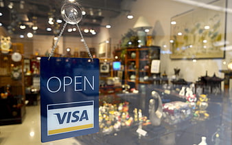 Open Visa sign hanging on antique shop window