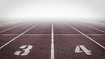 Empty Running Track Lanes in Foggy Morning Atmosphere