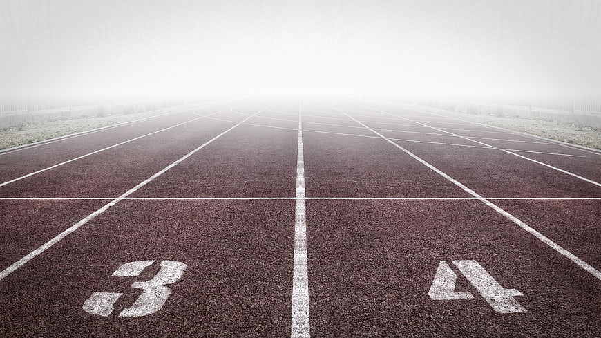 Empty Running Track Lanes in Foggy Morning Atmosphere