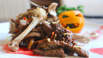 Halloween themed lamb chops with carved pumpkin garnish