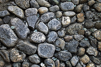 Close-up texture of gray and brown cobblestone pavement surface