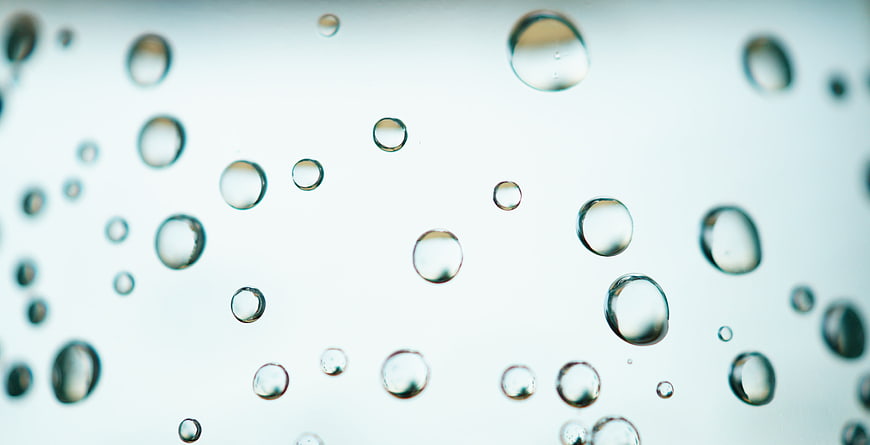 Macro Close-Up of Water Bubbles on a Light Blue Background