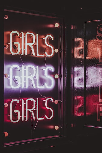 Neon Girls Sign in Dark Bar Interior