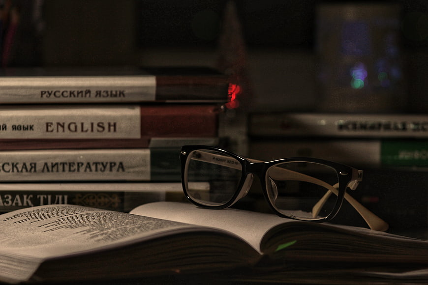 Glasses on Open Book with Russian and English Textbooks