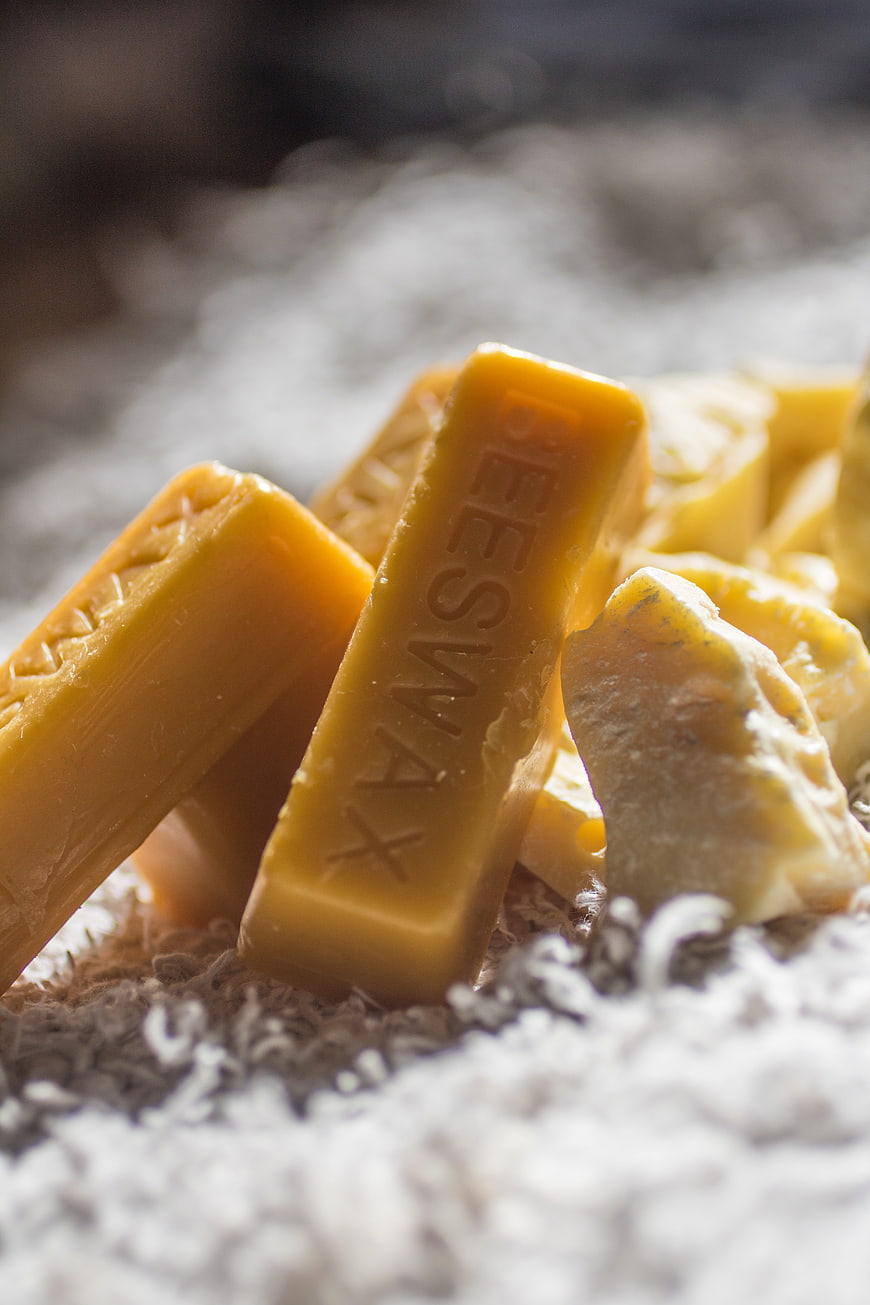Beeswax Bars and Raw Chunks on White Cotton Bedding