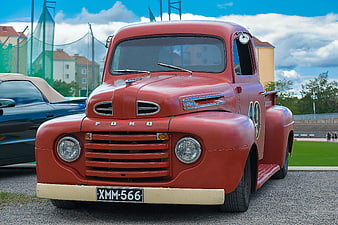 Vintage Red Ford Utility Truck Parked Outdoors