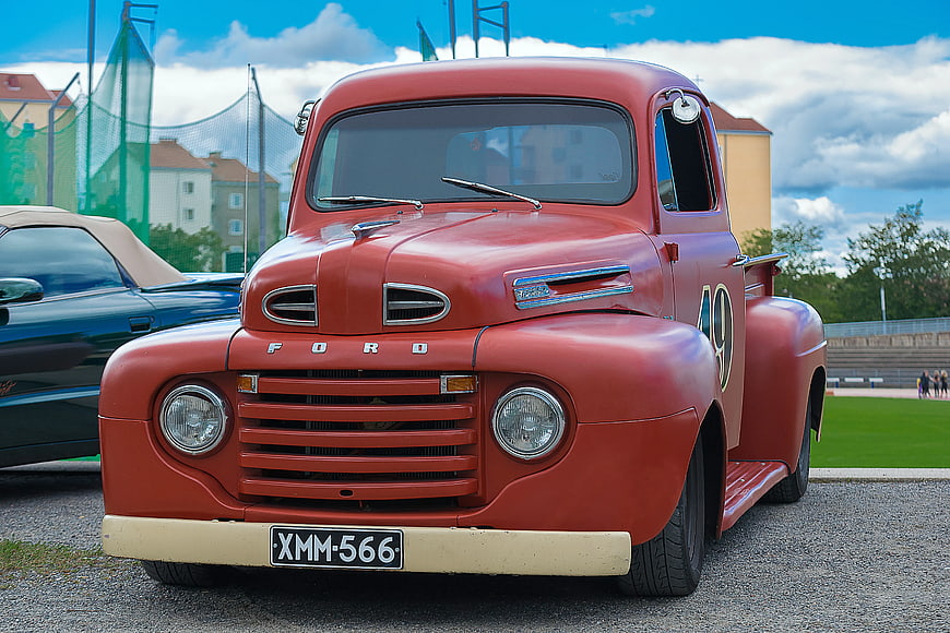 Vintage Red Ford Utility Truck Parked Outdoors