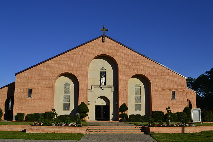 Modern Brick Church with Cross and Blue Sky