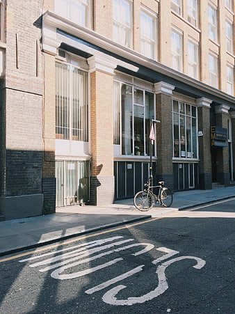 Vintage street scene with bicycle and bus stop road marking