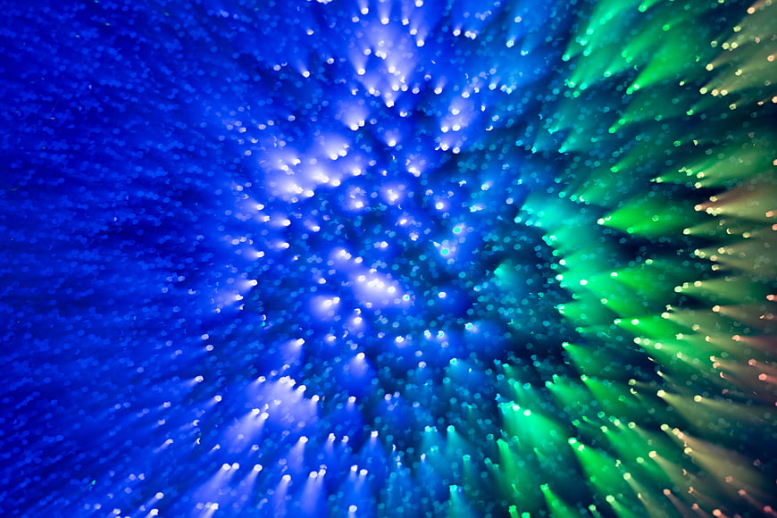 Abstract Blue and Green Bokeh Light Burst Background