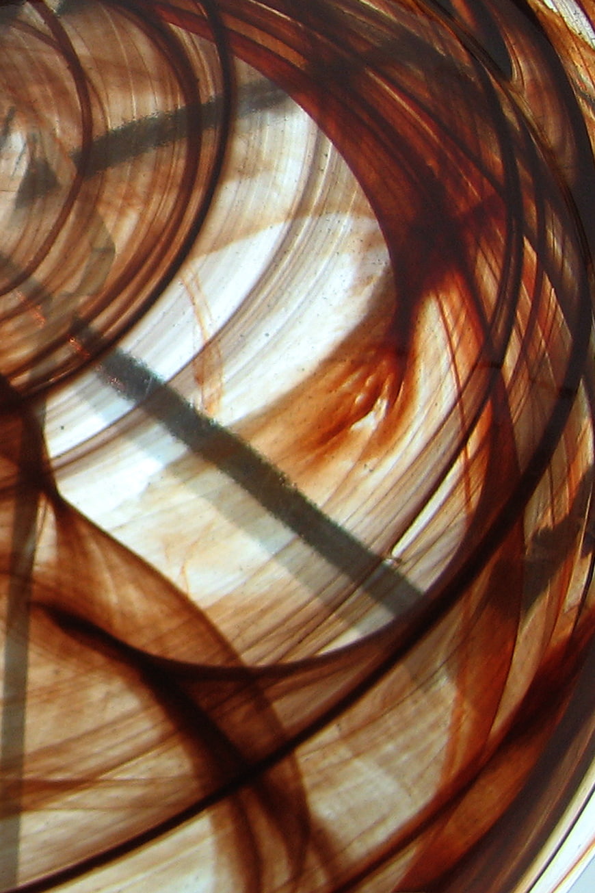 Abstract brown and white glass swirl texture close-up