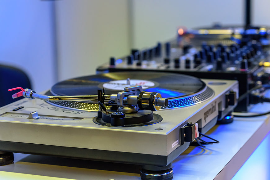 Close-up of DJ Turntable and Mixer with Blue Lighting
