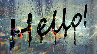 Handwritten Hello Text On Rainy Window With Blurred City Lights