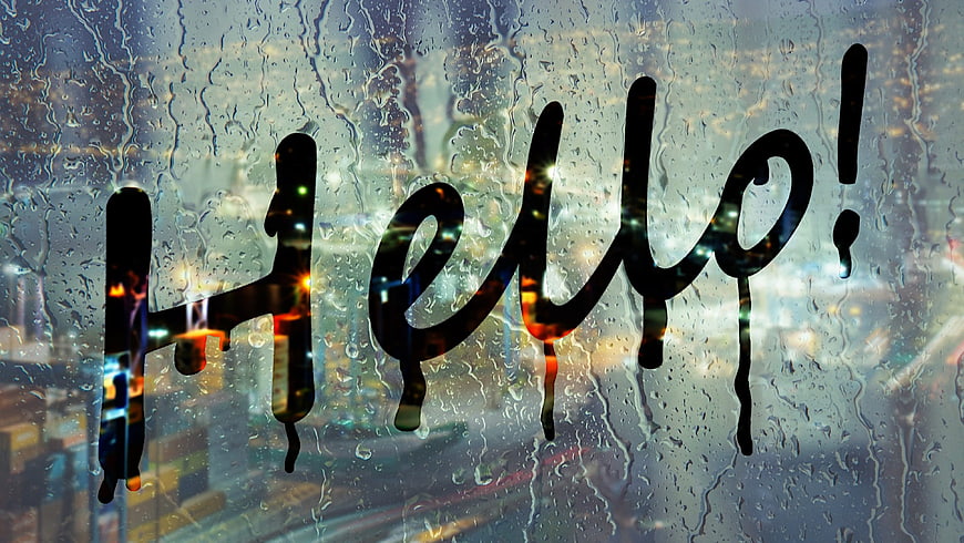 Handwritten Hello Text On Rainy Window With Blurred City Lights